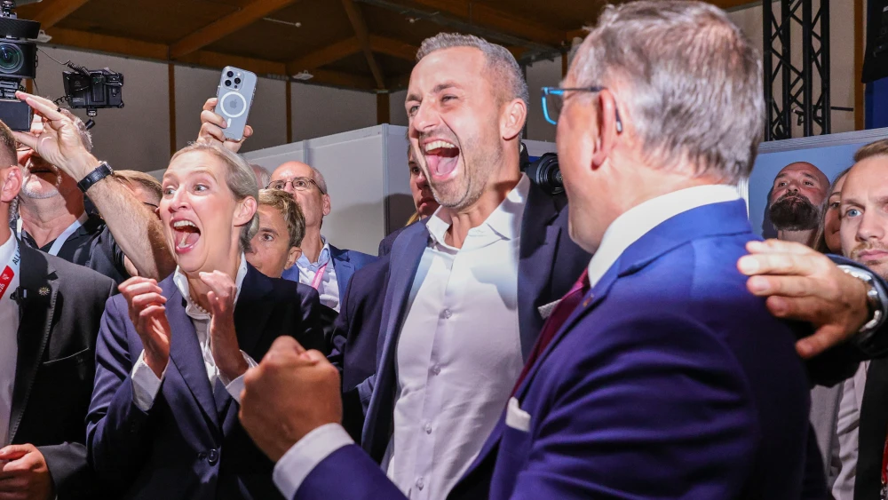 (From left) Co-Chairwoman of the Bundestag AFD faction Alice Weidel, Ulrich Siegmund, lead candidate of the far-right Alternative for Germany (AfD) and Co-Chairman of the Bundestag AFD faction Tino Chrupalla celebrate a first exit poll win to AFD at the Messe trade fair halls following state elections in Saxony-Anhalt on September 6, 2026 in Magdeburg, Germany. Photo by Omer Messinger/Getty Images.