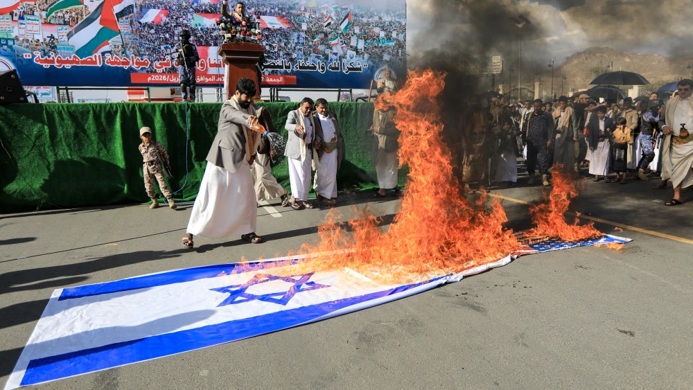 Supporters of the Iran-backed Houthi movement set fire to Israeli and US national flags as they rally in solidarity with Iran and Lebanon in the Yemeni capital Sanaa on April 10, 2026. Photo by Mohammed Huwais/AFP via Getty Images.