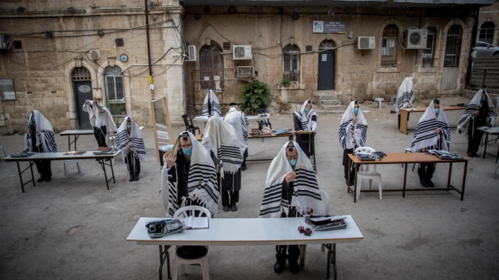 Chassidic Jews praying in accordance with social-distancing rules outside of their synagogue in Jerusalem on Aug. 10, 2020. Photo by Yonatan Sindel/Flash90.