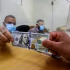 Palestinians receive financial aid from Qatar at a post office in Rafah in the southern Gaza Strip on Oct. 6, 2020. Photo by Abed Rahim Khatib/Flash90.