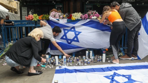 Israelis light candles at the scene of a deadly terror attack, on Dizengoff Street in central Tel Aviv. Photo by Noam Revkin Fenton/Flash90.