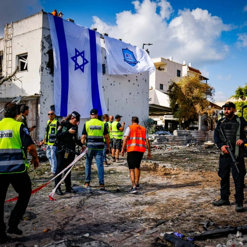 A giant Israeli flag covers the hole left by a rocket that terrorists from Lebanon fired at Kiryat Bialik, Israel, on Sept. 22, 2024. Photo by Chaim Goldberg/Flash90