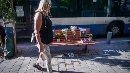 Candles and pictures of Chen Amir, a municipal patrolman killed by a terrorist, at the scene of the attack in Tel Aviv, Aug. 6, 2023. Photo by Avshalom Sassoni/Flash90.