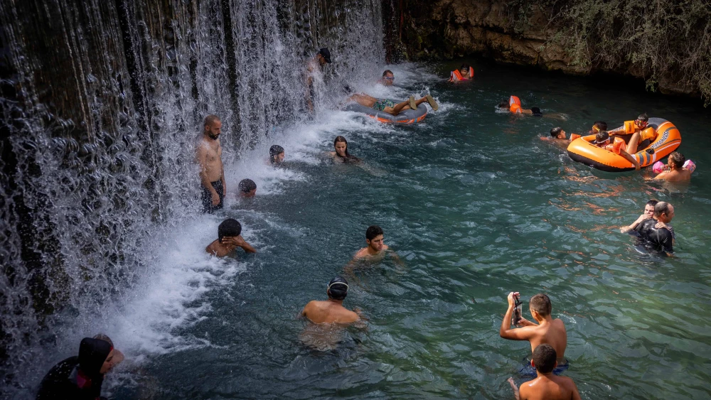 People enjoy the water in Gan Hashlosha National Park, aka Sakhne, in the Beit She'an Valley, during an extreme heat wave, Aug. 13, 2023. Photo by Yonatan Sindel/Flash90.