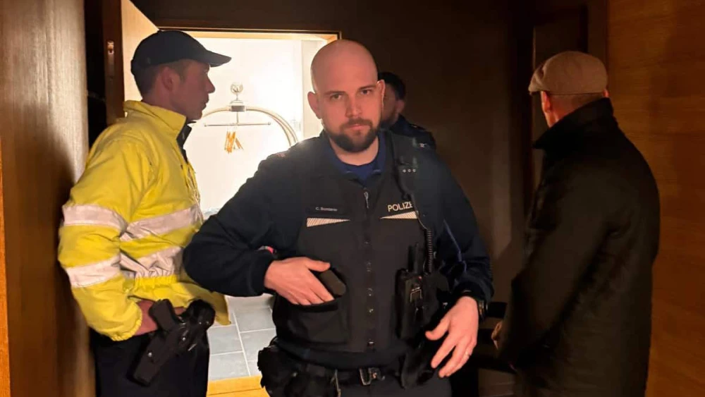 A Swiss police officer handling a call to evict Yaniv Bender and his family from a hotel in Arosa, Switzerland, on Jan. 14, 2025. Photo Courtesy of Bender.