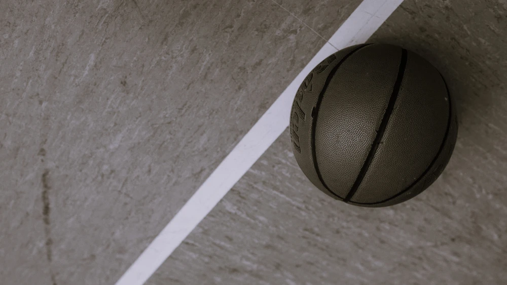 A basketball on a court. Credit: KoolShooters/Pexels.