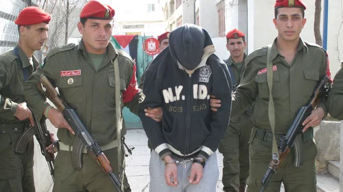 Mohanad Abo Jodah, an officer in Palestinian Authority leader Mahmoud Abbas's National Security Forces, is held by P.A. police after he was sentenced to death by a Palestinian military court in Hebron on Jan. 25, 2009. Credit: Najeh Hashlamoun/Flash90.
