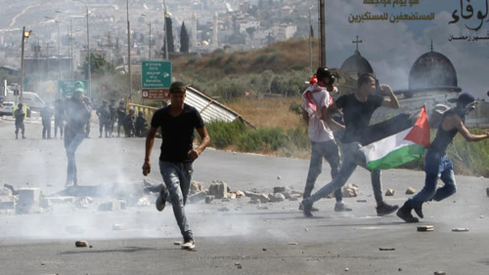 Palestinians hurl stones at Israeli security forces during a demonstration at the Huwara checkpoint, near Nablus, amid Muslim riots over Jerusalem’s Temple Mount holy site July 21, 2017. Photo by Nasser Ishtayeh/Flash90