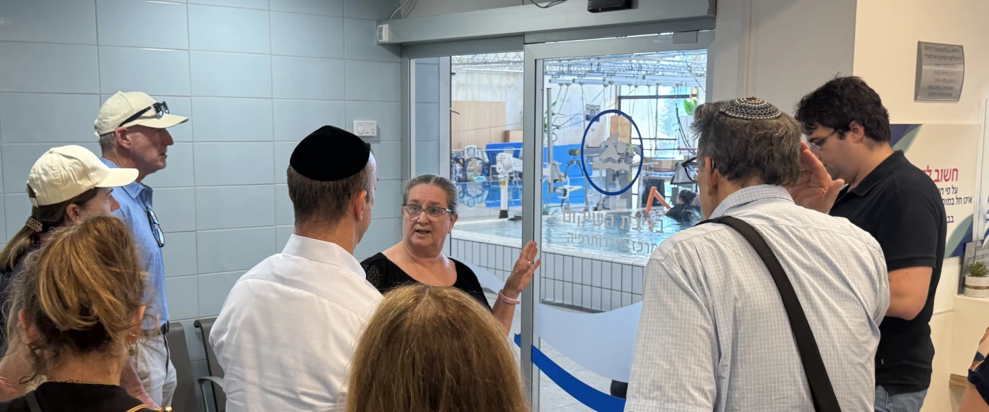 Professor Carolyn Barmatz shows hydrotherapy pools to a group of JNS Summit visitors at Sheba Medical Center in Tel Aviv, June 24, 2026. Photo by Howard Blas.
