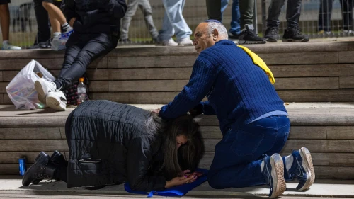 People take cover in Jerusalem as sirens warn of an incoming missile fired from Yemen, May 15, 2025. Photo by Oren Ben Hakoon/Flash90.