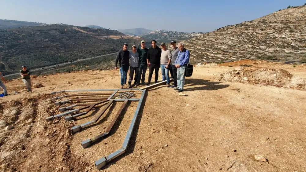 A delegation from Great Neck, N.Y., joins local youth to raise a large Chanukah menorah over the Shiloh Valley in Israel on Dec. 9, 2022. Credit: Courtesy of the Heartland Initiative.