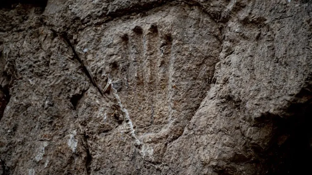 This 10th-century handprint was found in the moat surrounding Jerusalem's Old City. Photo by Yoli Schwartz/Israel Antiquities Authority.