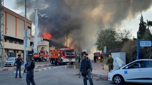 Israeli firefighters work to extinguish flames at a factory in Sderot ignited by a rocket launched by the Palestinian Islamic Jihad terror group over the Gaza border into Israel on Nov. 12, 2019. Photo by Flash90.