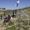 Palestinian students from Umm Al-Kheir are seen next to a newly erected fence around the Israeli community of Carmel, on April 13, 2026. Photo by Wisam Hashlamoun/Flash90.