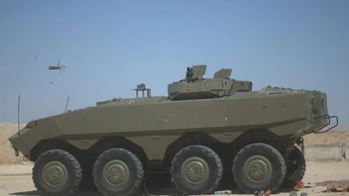 The Iron Fist active defense system mounted on an Eitan APC fires a projectile to intercept an incoming antitank missile. (Israeli Defense Ministry)