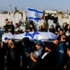 Mourners carry the body of 67-year-old Menahem Yehezkel, who was stabbed to death by a Bedouin Arab during a car-ramming attack in the southern Israeli city of Beersheva on March 22, during his funeral at a Beersheva cemetery on March 23, 2022. Photo by Olivier Fitoussi/Flash90.