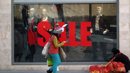 A woman dressed up in a costume for the Jewish holiday of Purim walks by a homeless man sleeping outside the Mashbir mall in the center of Jerusalem on March 7, 2012. Many Israeli organizations that are set up to help the poor go into high gear on Purim, to fulfill that holiday's mitzvah of gifts for the poor, in Hebrew "matanot l’evyonim." Credit: Nati Shohat/Flash90.