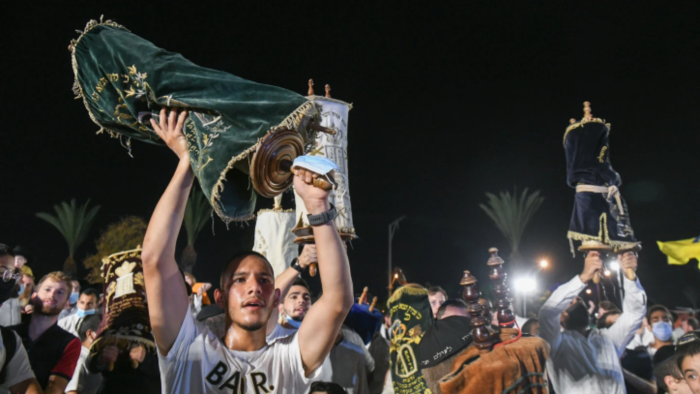 Jewish men carry Torah scrolls as they dance during Simchat Torah celebrations in Kfar Chabad on Sept. 28, 2021. Photo by Yossi Zeliger/Flash90.