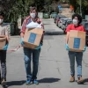 Young Israeli volunteers give away hot meals to elderly people unable to leave their homes because of the coronavirus outbreak, in Jerusalem on March 29, 2020. Photo by Yossi Zamir/Flash90.