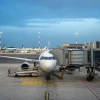 Airport employees finish loading luggage and an airport jetway or boarding bridge attached to a Eurowings low-cost airline plane parked on the tarmac at Rome Fiumicino Airport at dusk in Rome, Italy on June 18, 2025. Photo by Antoine Boureau / Hans Lucas / AFP via Getty Images.