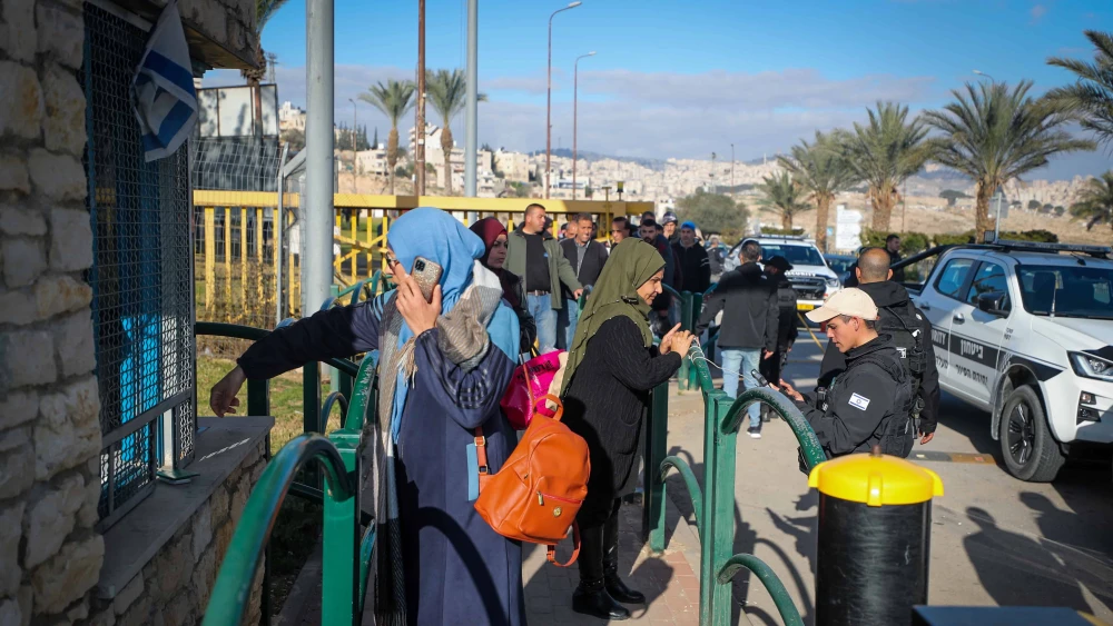 Palestinian workers line up at the entrance to the Israeli city of Ma'ale Adumim in Judea following an attempted stabbing attack, Feb. 23, 2023. Photo by Jamal Awad/Flash90.