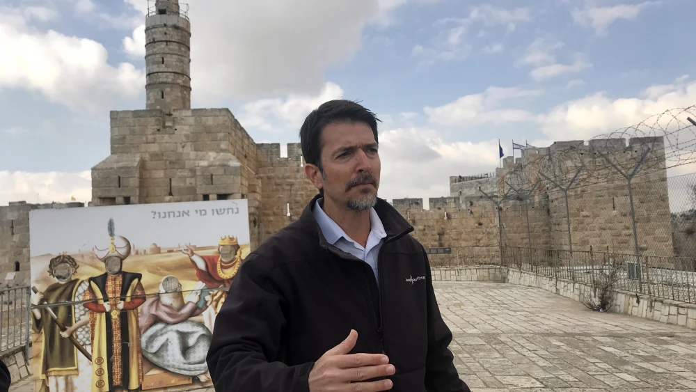 Amit Re’em, Jerusalem’s Chief Archaeologist at the Israel Antiquities Authority, standing on top of the Kishle Exhibit. Credit: Eliana Rudee.