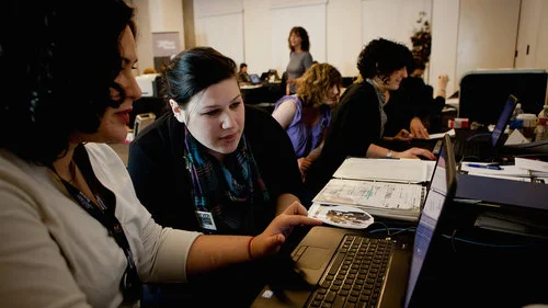 Sara-Joelle Clark (left), a U.S. Holocaust Memorial Museum researcher, shows documents she found in the International Tracing Service archive to Beckah Restivo, who was looking for information on her great-grandfather Felix. Credit: U.S. Holocaust Memorial Museum.