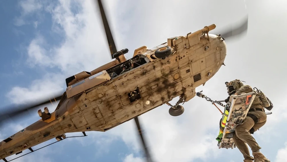 An Israel Defense Forces soldier is hoisted by a military helicopter, in an undated handout released by the military. Credit: IDF Spokesperson's Unit.