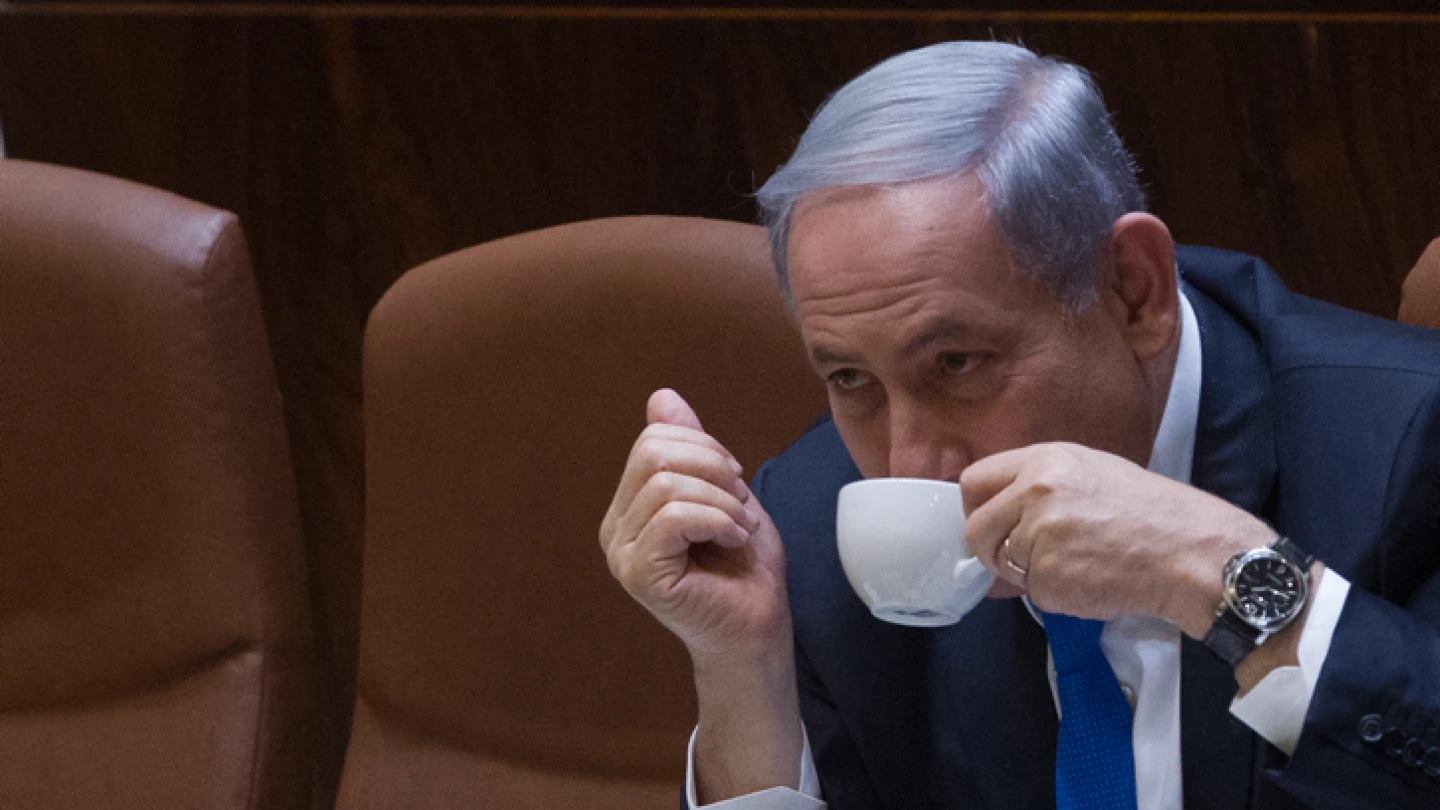 Israeli Prime Minister Benjamin Netanyahu seen drinking coffee during a plenum session in the assembly hall of the Israeli parliament on June 17, 2015. Photo by Miriam Alster/Flash90.