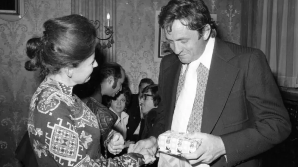Johnny Cash in conversation with a guest at the reception in his honor in Jerusalem, November 1971. Photo by IPPA Staff, the Dan Hadani Archive, the Pritzker Family National Photography Collection at the National Library of Israel.