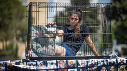 Relatives of Israelis held hostage by Hamas terrorists in Gaza sitting in cages protest for their release outside the Knesset in Jerusalem, July 10, 2024. Photo by Yonatan Sindel/Flash90.
