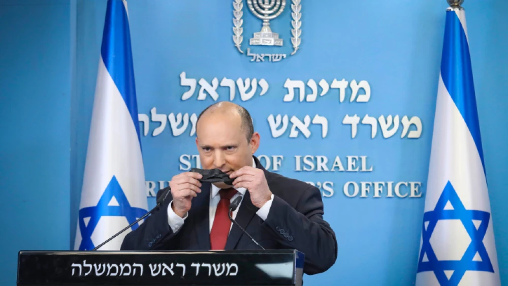 Israeli Prime Minister Naftali Bennett holds a press conference at the Prime Minister's Office in Jerusalem to talk about the "fifth wave" of the COVID-19 pandemic. Dec. 19, 2021. Photo by Marc Israel Sellem/POOL.