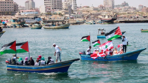 Palestinians hold flags during a rally at the seaport of Gaza City marking the fifth anniversary of the “Mavi Marmara” Gaza flotilla, May 31, 2015. Photo by Aaed Tayeh/Flash90.