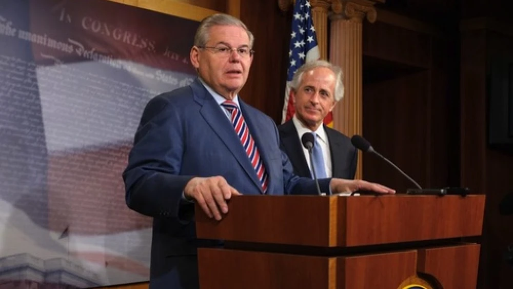 Sen. Robert Menendez (D-N.J.) speaks at a press conference in March that followed the Senate's passage of a bill on Ukraine. Looking on is Sen. Bob Corker (R-Tenn.), whose amendment proposing congressional oversight of a deal on the Iran nuclear program this month prompted Menendez, chair of the Senate Foreign Relations Committee, to withdraw the U.S.-Israel Strategic Partnership Act of 2013. Credit: Office of Sen. Robert Menendez.