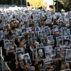People hold pictures of victims during a ceremony to commemorate the 31st anniversary the Mutual Israelite Association of Argentina (AMIA) bombing attack which left 85 dead and more than 300 wounded, in Buenos Aires on July 18, 2025. Photo by Luis Robayo / AFP via Getty Images.
