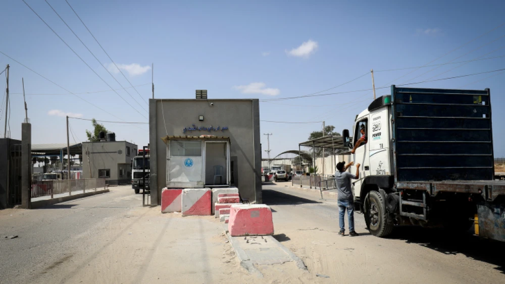Palestinian trucks loaded with aggregate, iron and cement enter through the Kerem Shalom commercial crossing in the southern Gaza Strip, on Sept. 1, 2021. Photo by Abed Rahim Khatib/Flash90.