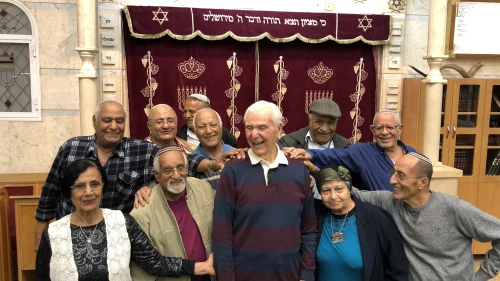Capt. Elgen Long is embraced by Yemenite Jews during a visit to Israel last fall. Credit: Shahar Azani.