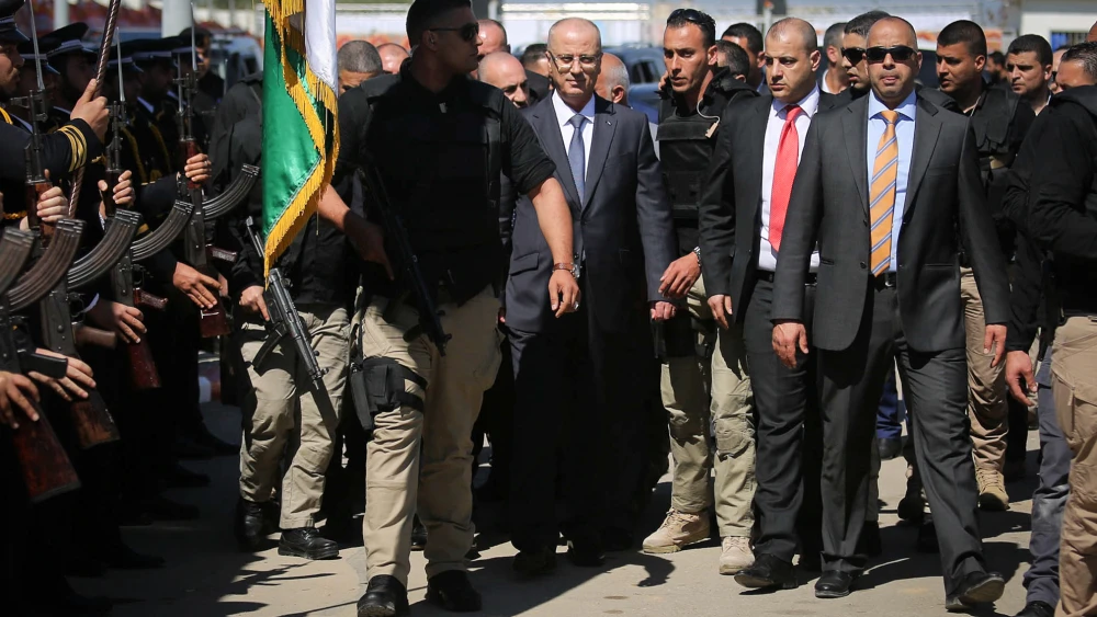 Palestinian Authority Prime Minister Rami Hamdallah, escorted by bodyguards, is greeted by Palestinian policemen upon his arrival in Gaza City on March 13, 2018. Credit: Abed Rahim Khatib/Flash90.