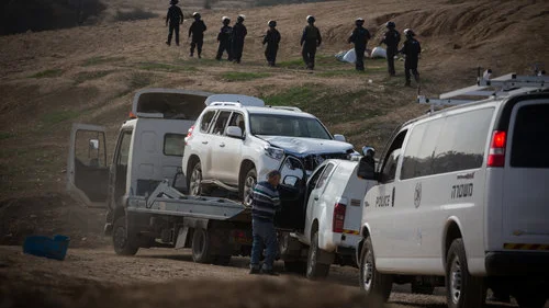 A tow truck removes the vehicle driven in the Jan. 18 car-ramming that killed Israel Police Advanced Staff Sgt. Maj. Erez Levi, 34, during protests against the demolition of the illegal Bedouin village of Umm al-Hiran. Israeli officials described the incident as a terrorist attack. Credit: Hadas Parush/Flash90.