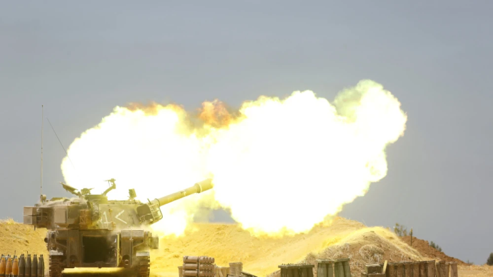 An IDF tank fires into the Gaza Strip near the border following multiple days of heavy rocket and missile barrages launched into Israel by terror factions in Gaza, May 12, 2021. Photo by Yonatan Sindel/Flash90.