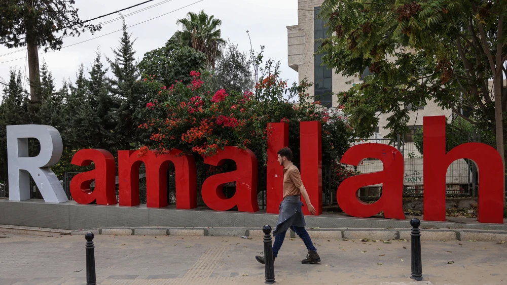 A pedestrian walks along a street in Ramallah, in Judea and Samaria, on Oct. 11, 2026. Photo by Zain Jaafar/AFP via Getty Images.