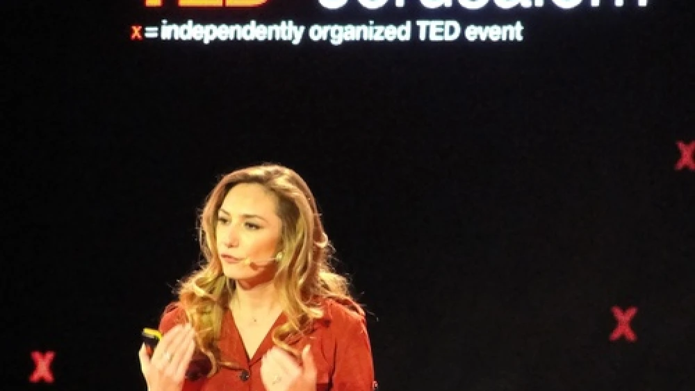 Click photo to download. Caption: Michal Ansky, a food journalist and television presenter, speaks at the Dec. 10 TEDx conference in Jerusalem. Credit: Judy Lash Balint.