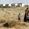 A woman and her children walk towards the town of Kochav HaShahar in the Binyamin region of Samaria, June 4, 2009. Photo by Abir Sultan /Flash90.