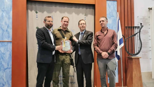 Aviad Gizbar (second from left) receives a certificate of appreciation from Israeli President Isaac Herzog and Binyamin Regional Council head Israel Ganz (left). Credit: Binyamin Regional Council.