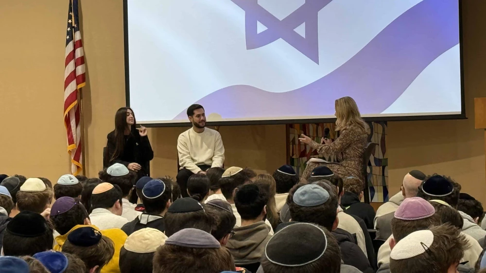 Former Israeli hostage Eliya Cohen, held by Hamas in Gaza, and his fiancée, Ziv Amud, speak to students at The Frisch School in New Jersey. Credit: Courtesy.