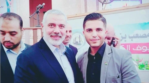 Mohammed Alkhatib, right, with Ismail Haniyeh. A screenshot from a report by JID.