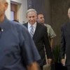 Click photo to download. Caption: Prime Minister Benjamin Netanyahu (center) is accompanied by Prof. Manuel Trajtenberg (far right), who headed the Trajtenberg Committee Report on social changes, on his way to a cabinet meeting on Oct. 3, 2011. Credit: EPA/JIM HOLLANDER/POOL.