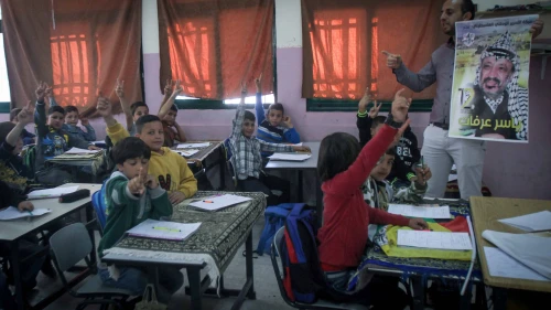 A Palestinian teacher lectures at the Salem School for Girls in Nablus on the life of Yasser Arafat, on the 12th anniversary of his death, Nov. 10, 2016. Photo by Nasser Ishtayeh/Flash90.