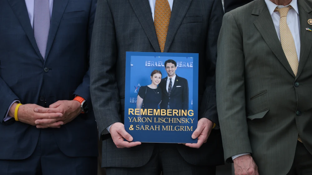 Members of Congress hold photos during a memorial vigil for two Israeli embassy staff members, Yaron Lischinsky, 30, and Sarah Lynn Milgrim, 26, outside of the U.S. Capitol in Washington, D.C., on June 10, 2025. Credit: Kayla Bartkowski/Getty Images.