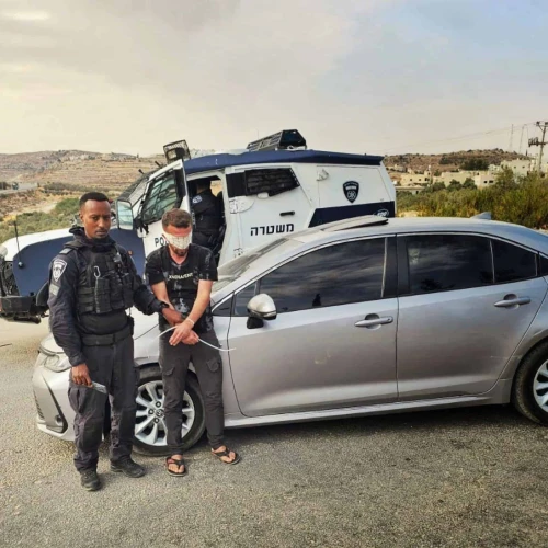 An Israeli police officer detains a Palestinian suspect in an undisclosed location in Judea and Samaria, as part of the law enforcement operation “Stopping at Red,” carried out in August, 2025. Credit: Israel Police.